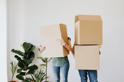 A couple holding lots of boxes