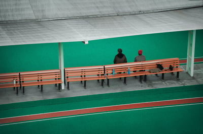 Photo of people sitting on a bench